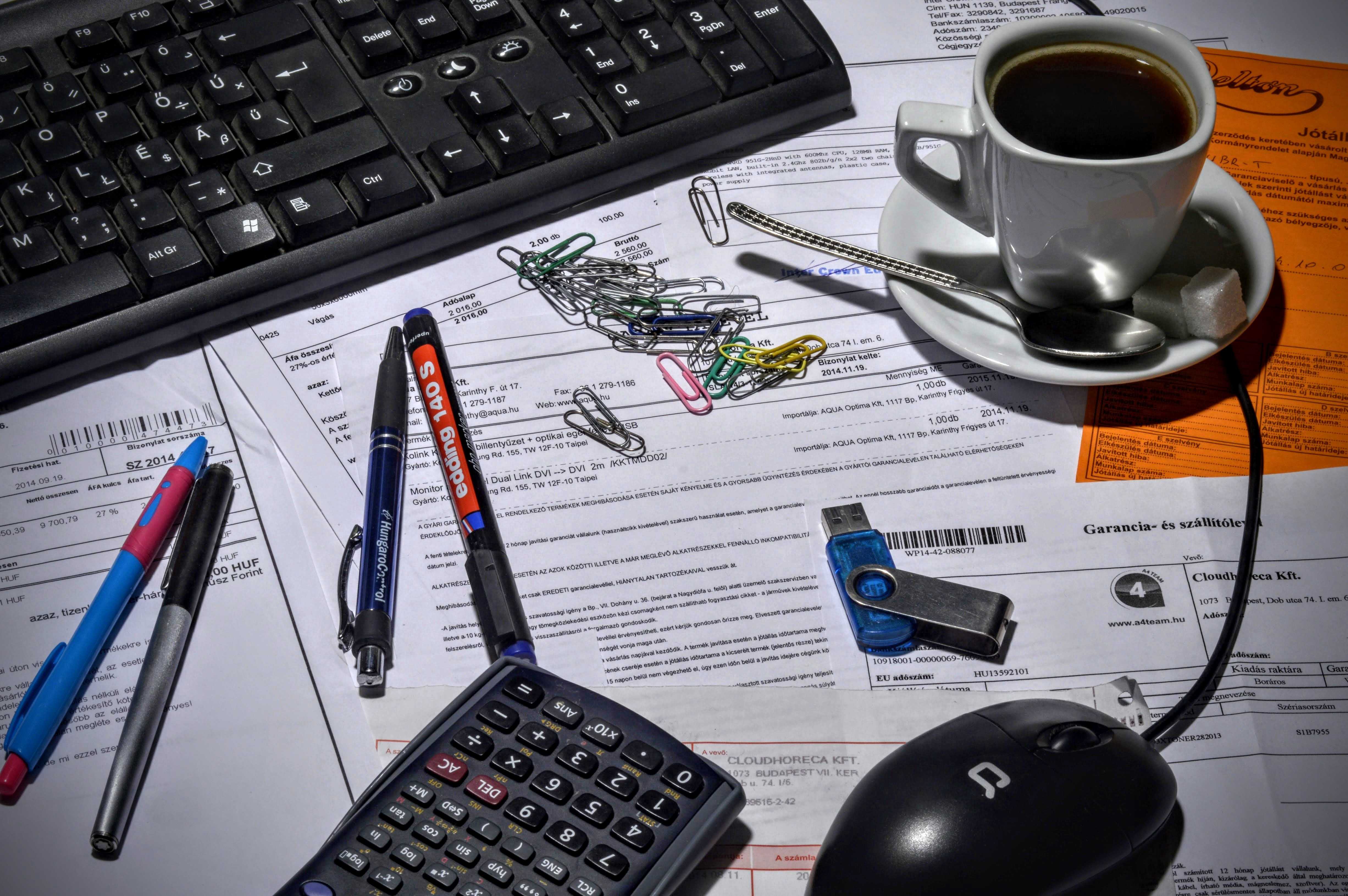 desk with keyboard coffee and stationery